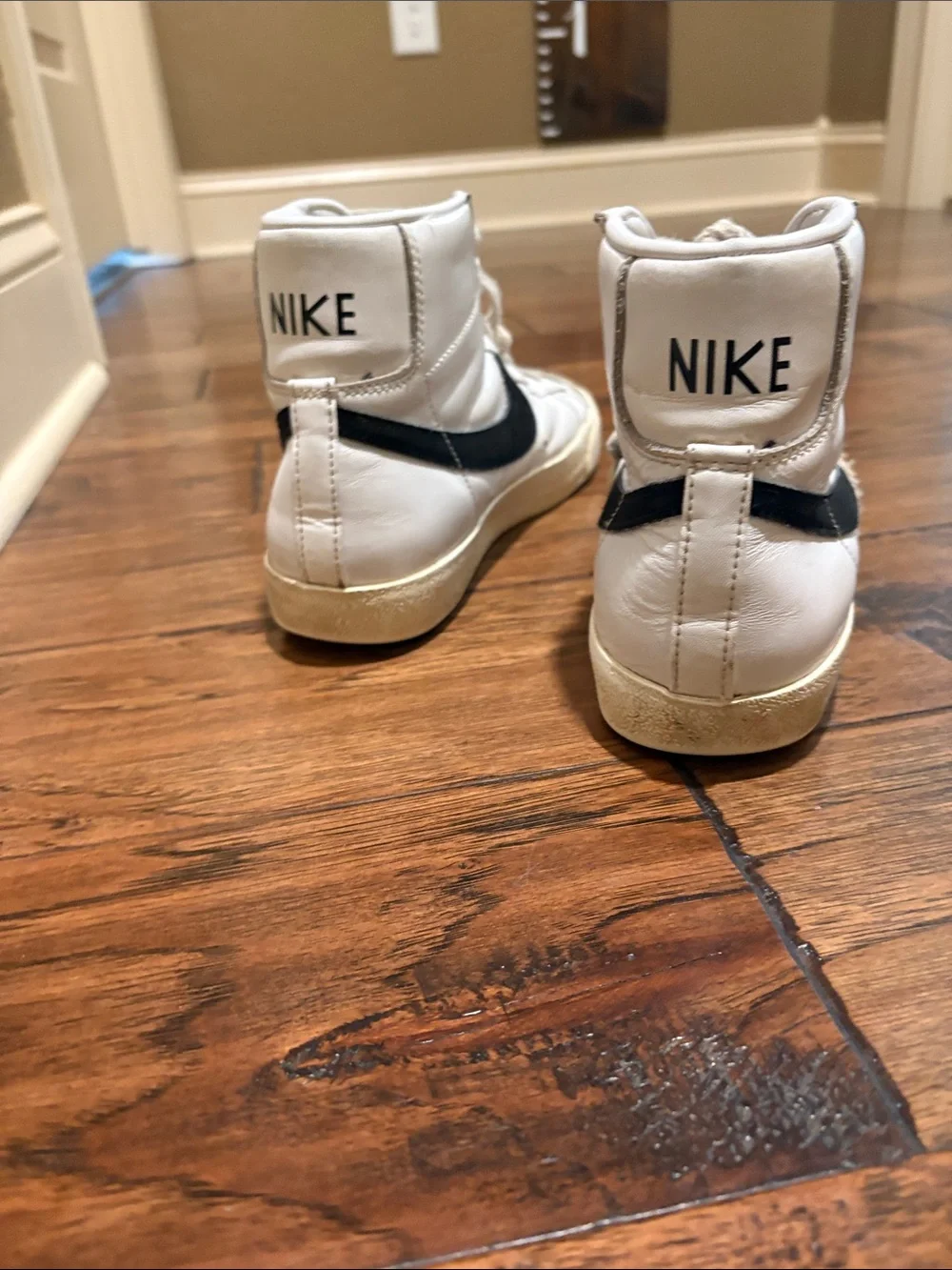 Nike White High-Top Sneakers with Black Swoosh